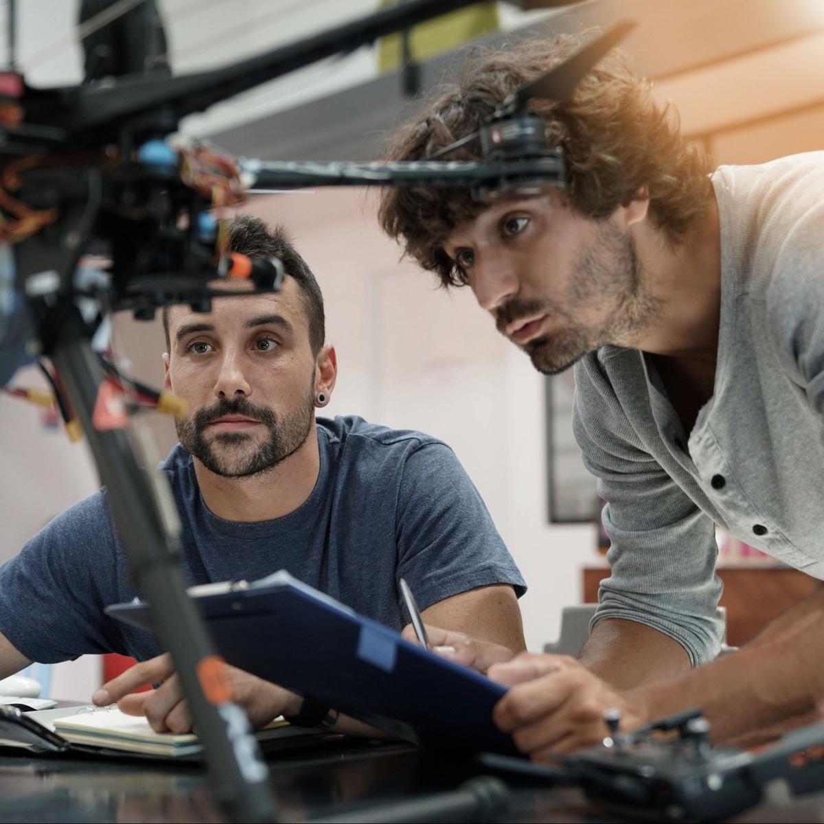 Two engineers inspecting an assembly against the acceptance criteria