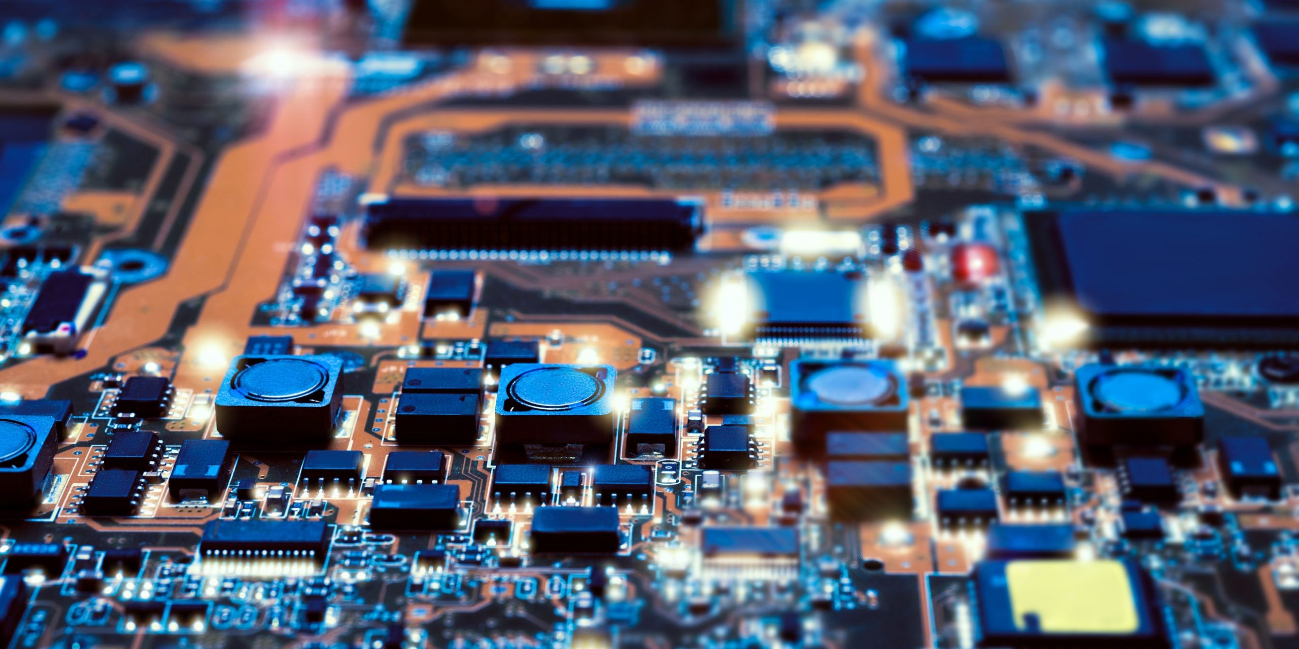 Closeup on electronic board in hardware repair shop, blurred and toned image. Shallow DOF, focus on the middle left field