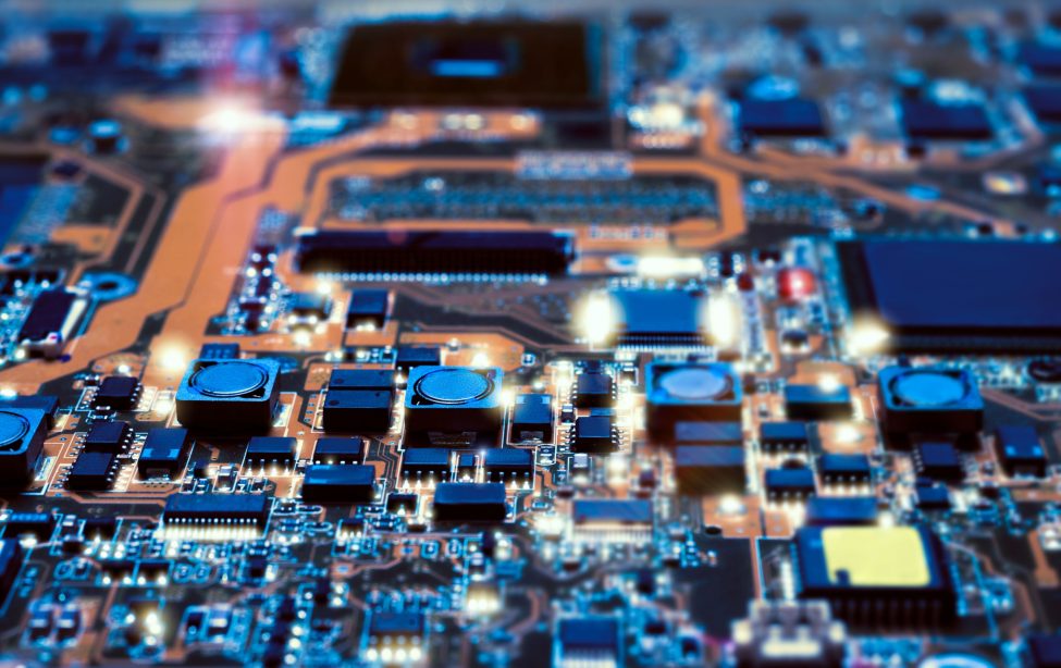 Closeup on electronic board in hardware repair shop, blurred and toned image. Shallow DOF, focus on the middle left field