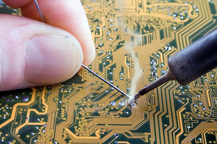 ipc 7711 certification soldering with a soldering iron and lead on a board