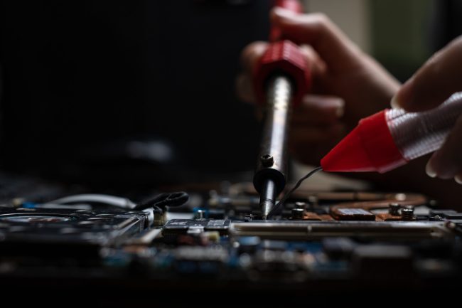 Close-up hand technician repairing broken laptop notebook comput ipc certification