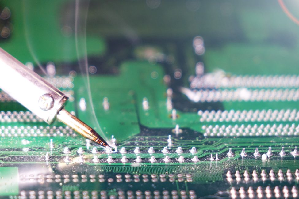 94363385_m_normal_none Soldering to a circuit Board of a computer close up